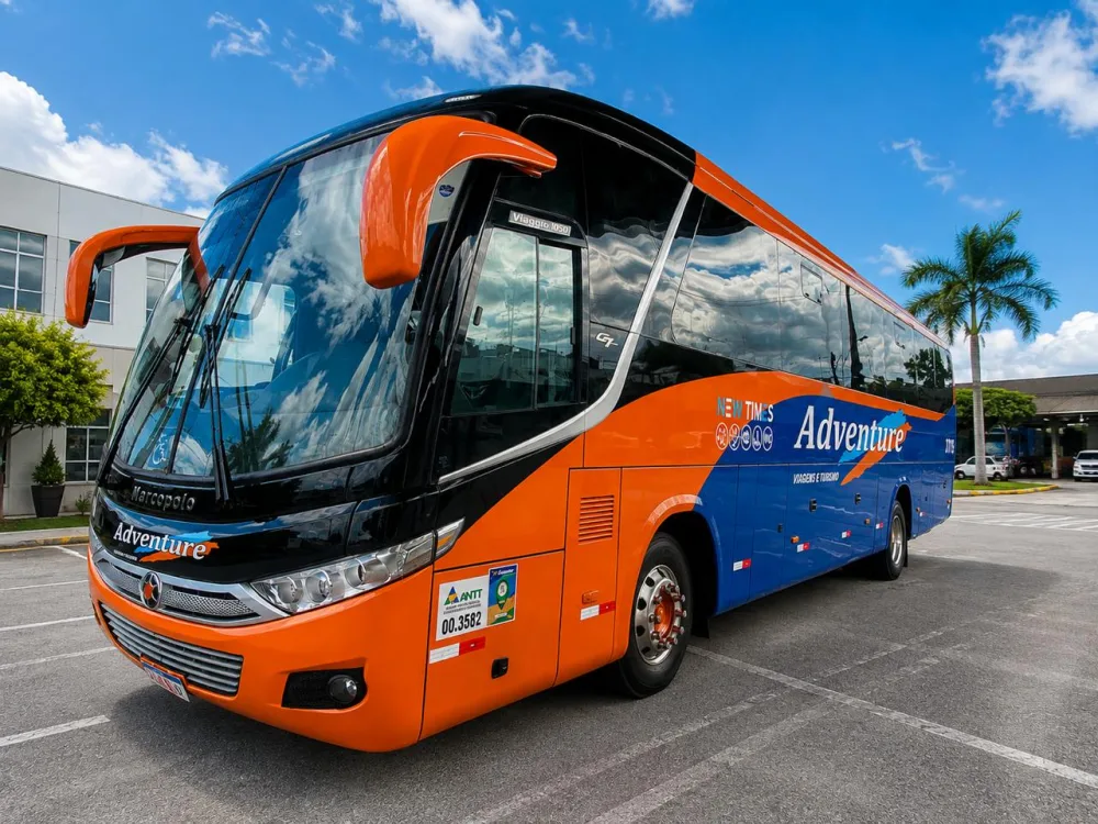 Ônibus rodoviário da frota Adventure Viagens e Turismo, na identidade laranja e azul da empresa.